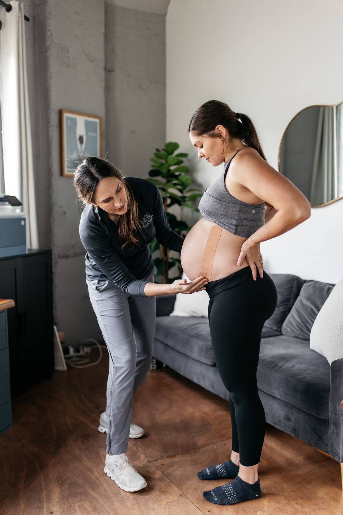 Pregnant mom receiving pelvic floor physical therapy support